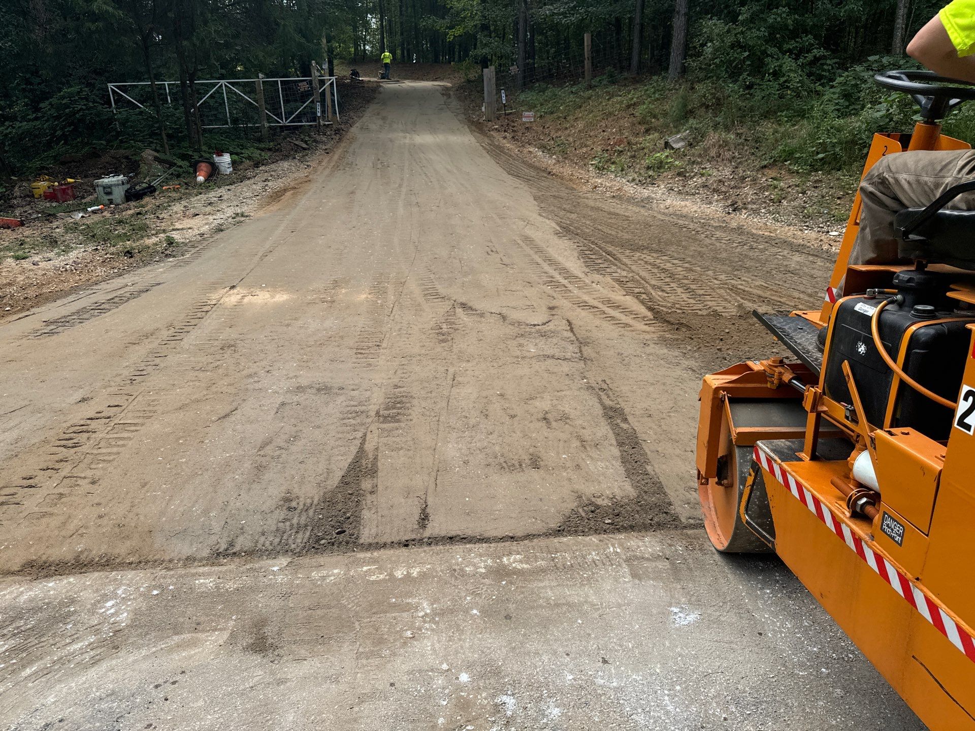Paving roller preparing a gravel base for asphalt